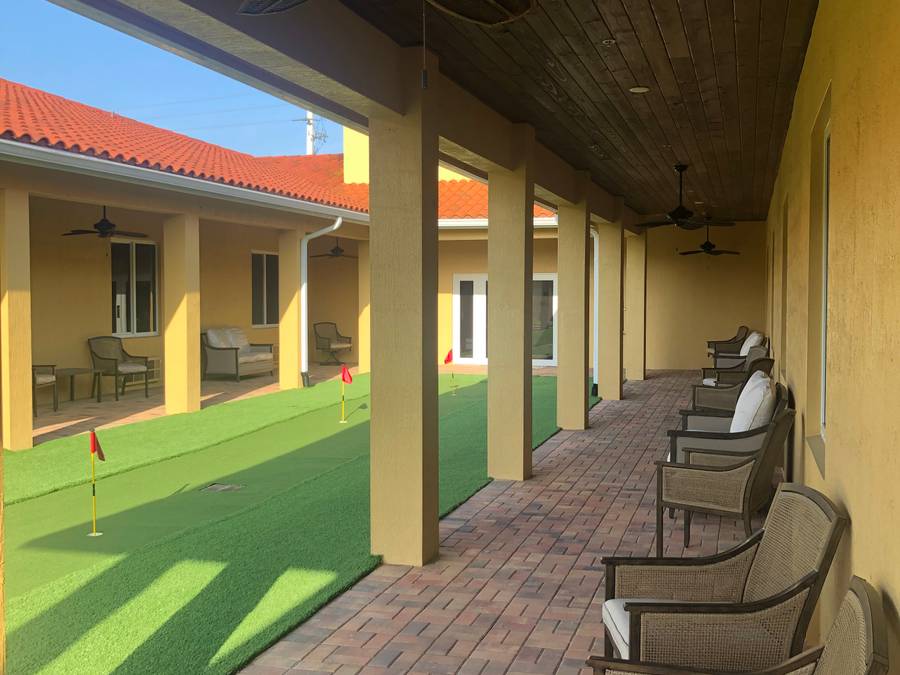Shaded putting green in the secure courtyard at The Manor of Fort Pierce